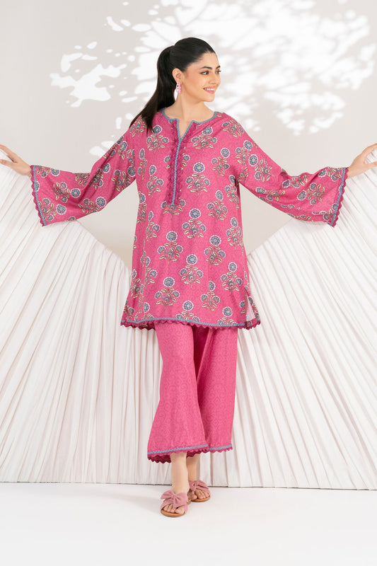 Woman wearing a pink traditional outfit with a floral pattern on a white background