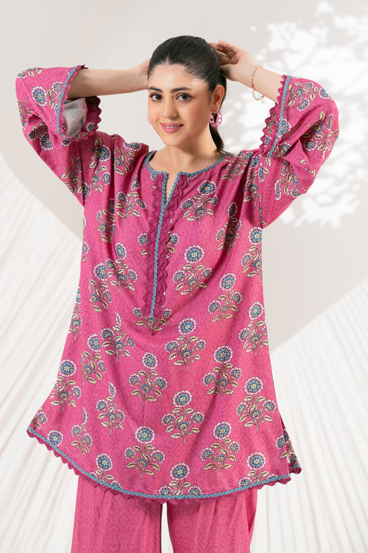 Woman wearing a pink traditional outfit with floral patterns on a white background