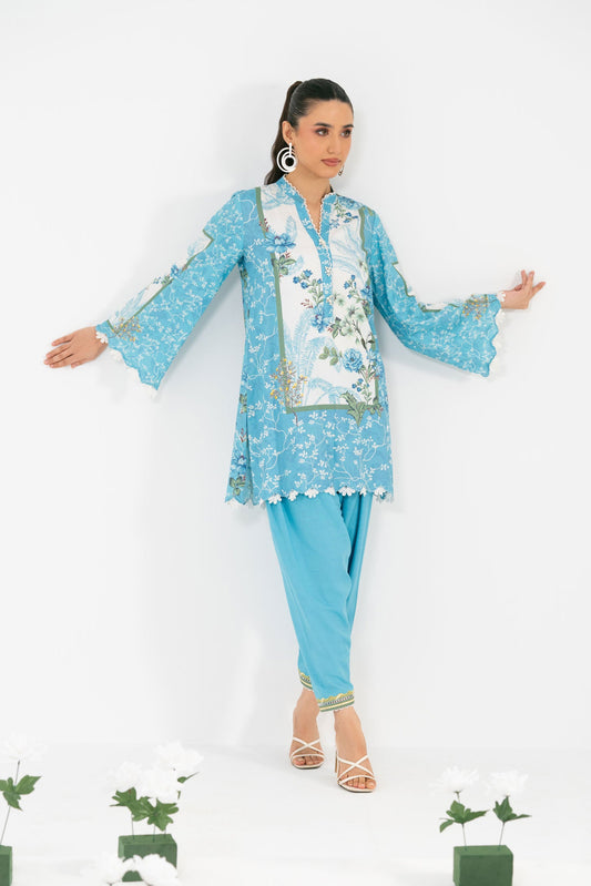 Woman in a light blue traditional outfit with floral patterns on a white background