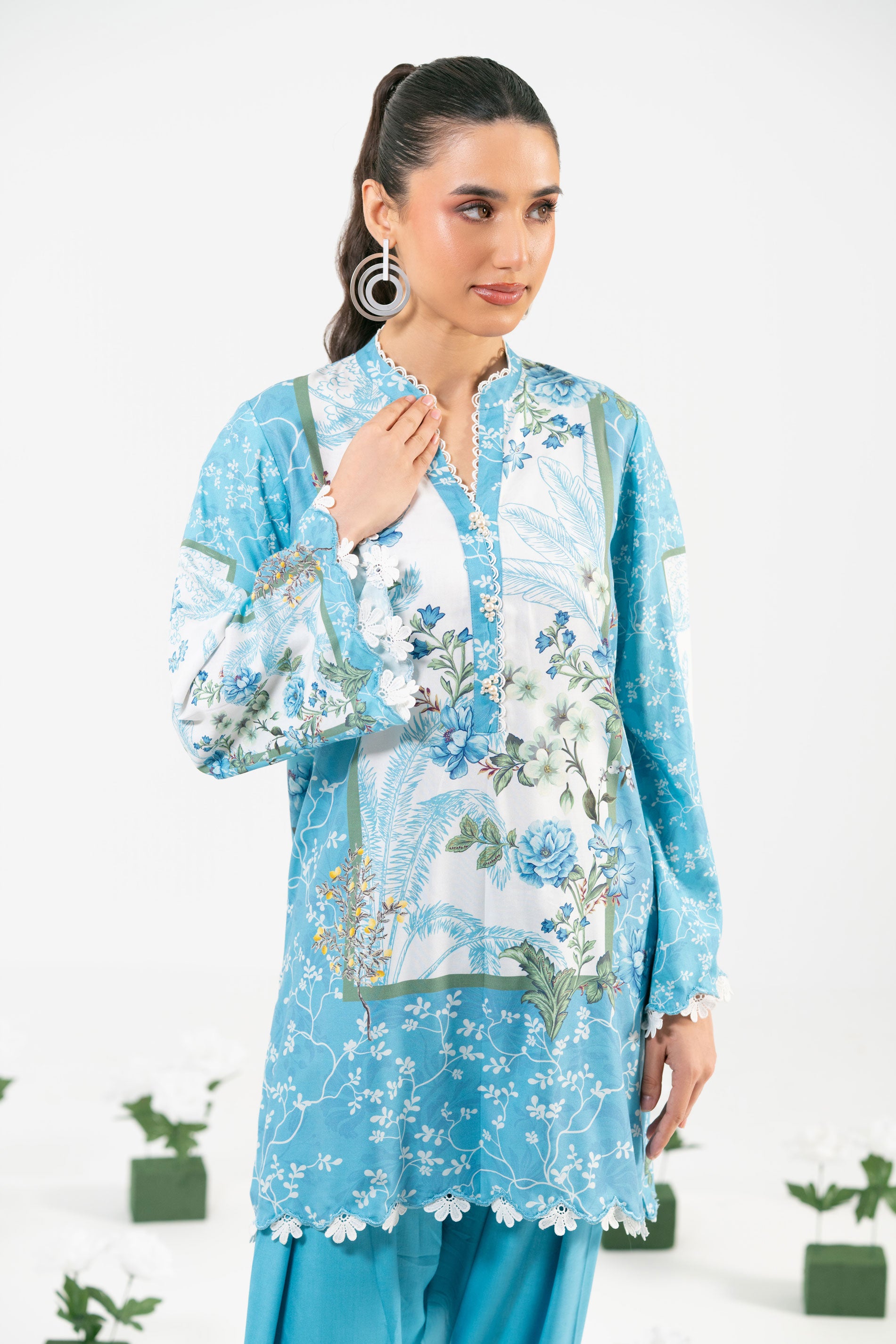 Woman wearing a blue floral outfit with a white background