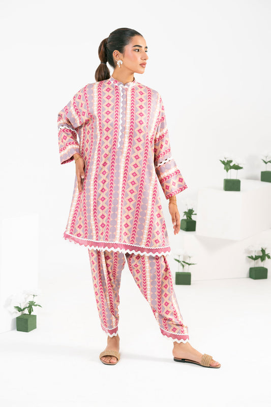Woman wearing a pink and white patterned outfit on a white background